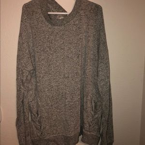 Gray sweater with cross detailing in bottom sides